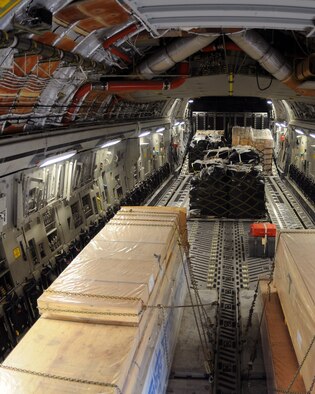JOINT BASE CHARLESTON, S.C. -- Ten pallets of food and building materials in support of relief operations in Haiti, sit in a C-17 Globemaster III from Altus Air Force Base, Okla., before being delivered. The food and building materials were delivered by members of the 58th Airlift Squadron, and was made possible by the Denton Program, which allows donors to use space available on U.S. military cargo aircraft to transport humanitarian goods and equipment to countries in need. (U.S. Air Force photo by Airman 1st Class Kenneth W. Norman)