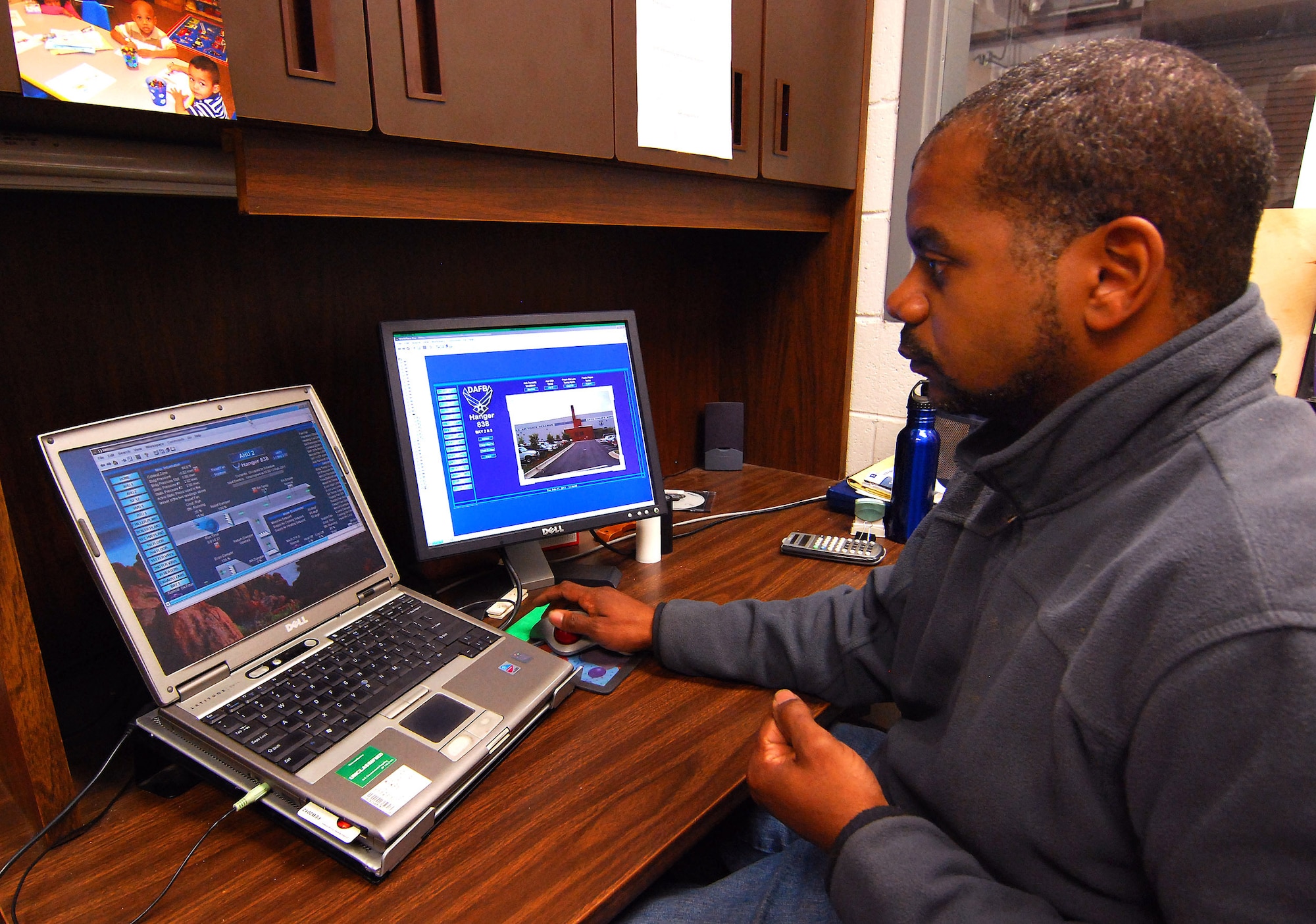 Mr. Dominic Turner demonstrates the capabilities of the Energy Management Control System from the 94th Civil Engineer Squadron headquarters building, Feb. 17.  This system allows central control of the environmental services throughout Dobbins base facilities from this laptop located in CE.  This type of systems management, until recently, required large banks of computer controlled equipment to centrally manage these systems.  Mr. Turner is with the Base Operations Support Services contractor, DMS.  (U.S. Air Force photo/ Brad Fallin)