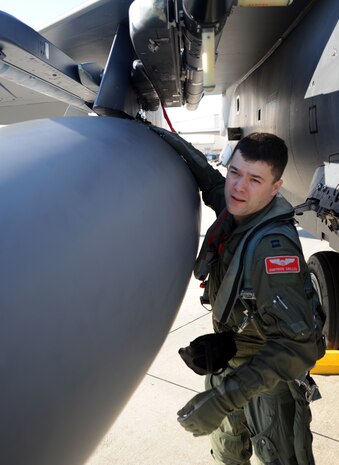 Capt. Tacos Grillos performs a final inspection on his F-15E Strike Eagle before entering the cockpit for training on the flight line Feb. 23 on Joint Base Charleston - Air Base, S.C. The Strike Eagle is a dual-role fighter designed to perform air-to-air and air-to-ground missions. An array of avionics and electronics systems gives the aircraft the capability to fight at low altitudes, day or night, in all weather. Captain Grillos is a student pilot with the 333rd Fighter Squadron from Seymour Johnson Air Force Base. (U.S. Air Force photo/Senior Airman Timothy Taylor)

