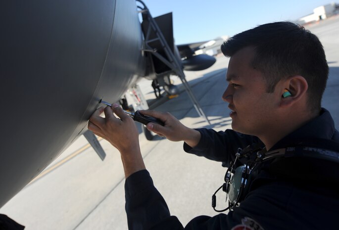 Staff Sgt. Ramon Salas secures nose panels on an F-15E Strike Eagle pre-flight on the flight line Feb. 23 on Joint Base Charleston-Air Base. The 333rd Fighter Squadron is actively engaged in a week-long exercise. The exercise is the culmination of the eight months of training for the 22 pilots and weapons systems officers in the class. Sergeant Salas is a crew chief with the 333rd Aircraft Maintenance Squadron from Seymour Johnson Air Force Base. (U.S. Air Force photo/Senior Airman Timothy Taylor)
