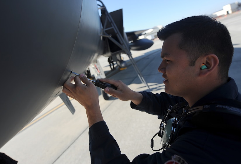 Staff Sgt. Ramon Salas secures nose panels on an F-15E Strike Eagle pre-flight on the flight line Feb. 23 on Joint Base Charleston-Air Base. The 333rd Fighter Squadron is actively engaged in a week-long exercise. The exercise is the culmination of the eight months of training for the 22 pilots and weapons systems officers in the class. Sergeant Salas is a crew chief with the 333rd Aircraft Maintenance Squadron from Seymour Johnson Air Force Base. (U.S. Air Force photo/Senior Airman Timothy Taylor)