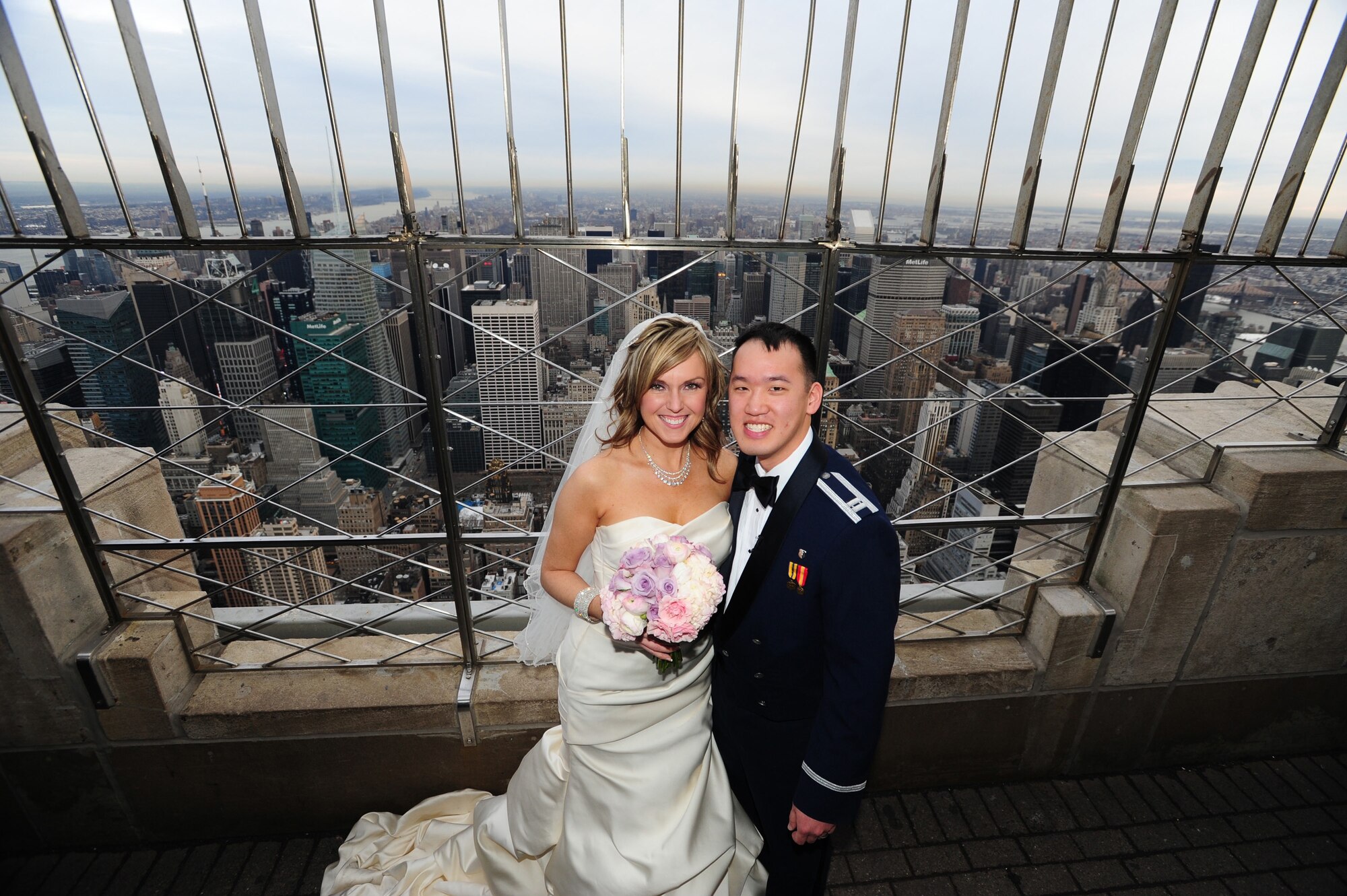 NEW YORK - Capt. John Wu and spouse Stephanie stand atop the Empire State Building Feb. 14. The Wu couple found themselves not only as one of 14 couples selected to get married at the Empire State Building, but as the grand-prize winners they also received a four-day honeymoon to the Bahamas. (Courtesy Photo)