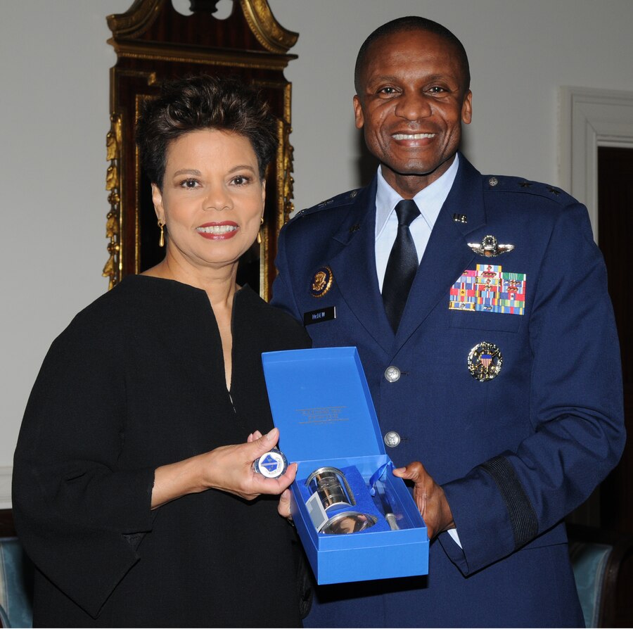 Maj. Gen. Darren W. McDew, commander of the Air Force District of Washington, presents Maureen Bunyan, anchor for ABC7/WJLA-TV, with a commander’s coin and gift Feb. 20 for her participation in The U.S. Air Force Band's 2011 Guest Artist Series at the DAR Constitution Hall, Washington, D.C. Ms. Bunyan participated as the guest emcee for the concert. (U.S. Air Force photo by Senior Airman Christopher Ruano)
