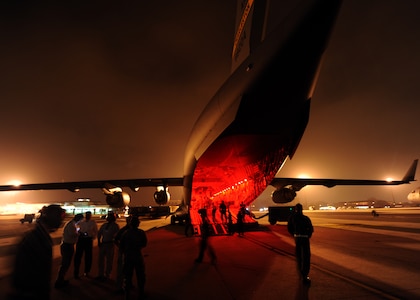 Honorary Commanders venture outside a C-17 Globemaster III during night vision goggle training Feb. 22 on Joint Base Charleston, S.C. Honorary Commanders were given the opportunity to dine on the C-17 and ask the crew questions about the aircraft and their missions. (U.S. Air Force photo/Senior Airman Timothy Taylor)