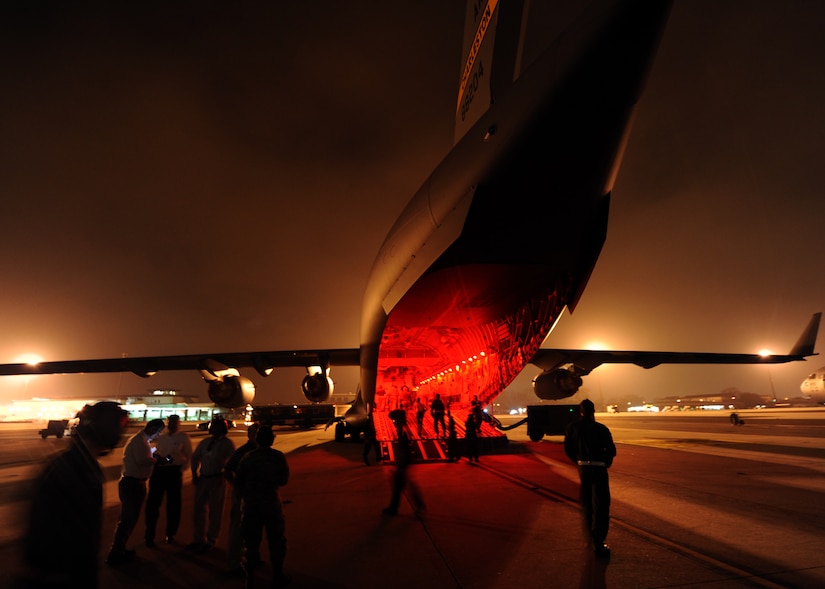 Honorary Commanders venture outside a C-17 Globemaster III during night vision goggle training Feb. 22 on Joint Base Charleston, S.C. Honorary Commanders were given the opportunity to dine on the C-17 and ask the crew questions about the aircraft and their missions. (U.S. Air Force photo/Senior Airman Timothy Taylor)