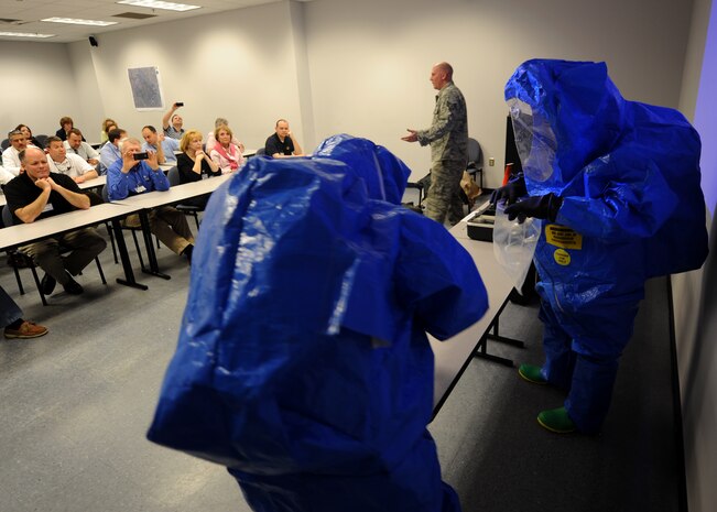 Staff Sgt. Brandon Barnes explains safety procedures in a contaminated environment during chemical, biological, radiological and nuclear training at the Logistics Readiness Squadron warehouse Feb 22 on Joint Base Charleston, S.C. During the CBRNE training, Honorary Commanders learned military procedures for detecting harmful airborne elements and protective safety measures. (U.S. Air Force photo/Senior Airman Timothy Taylor)