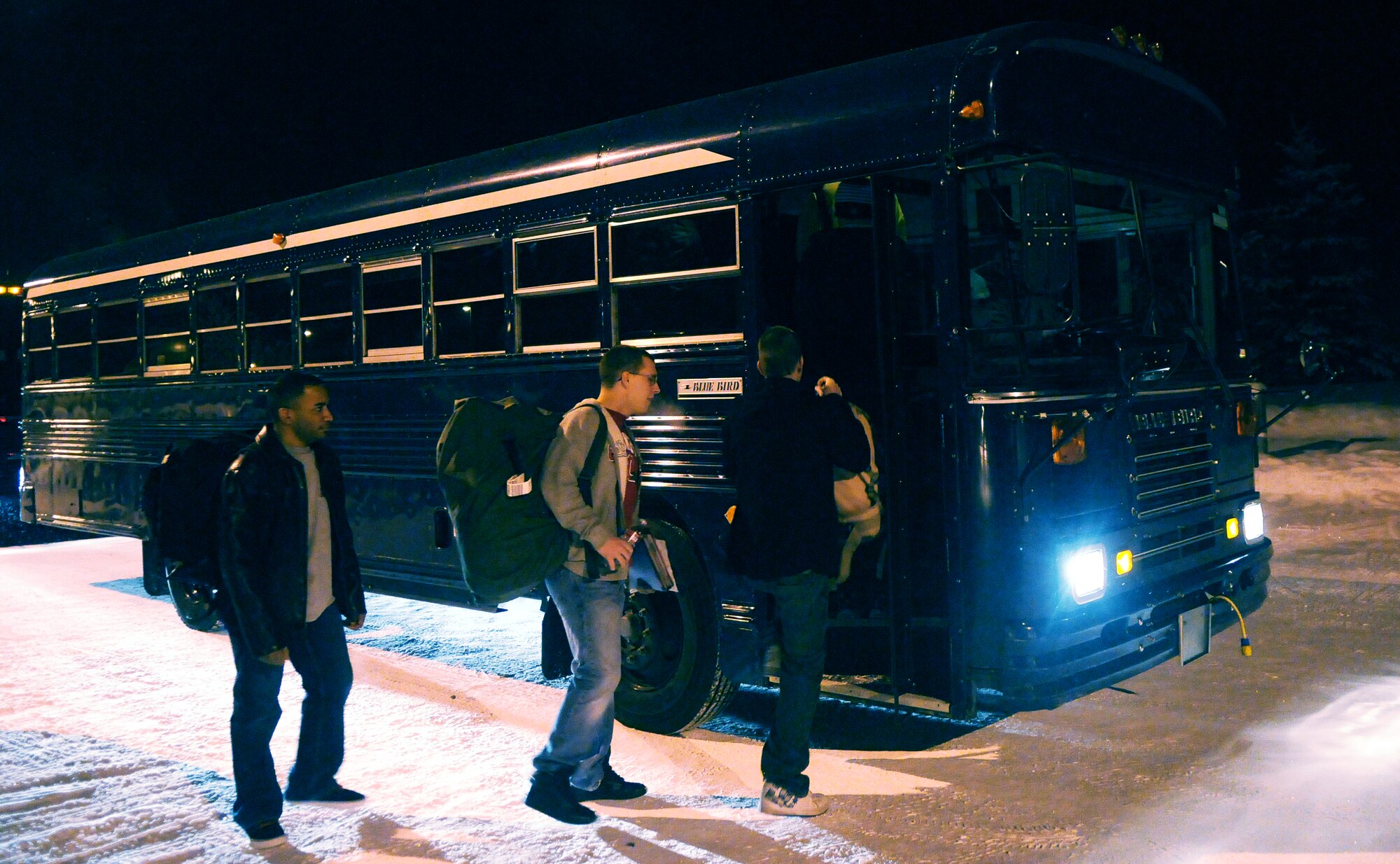 Airmen with the 354th Civil Engineer Squadron board a bus for transportation to the airport for an early flight Feb. 5, 2011, Eielson Air Force Base, Alaska. The Airmen flew to Kadena Air Base to participate in a two week Silver Flag traning exercise. (U.S. Air Force photo/Airman 1st Class Janine Thibault)