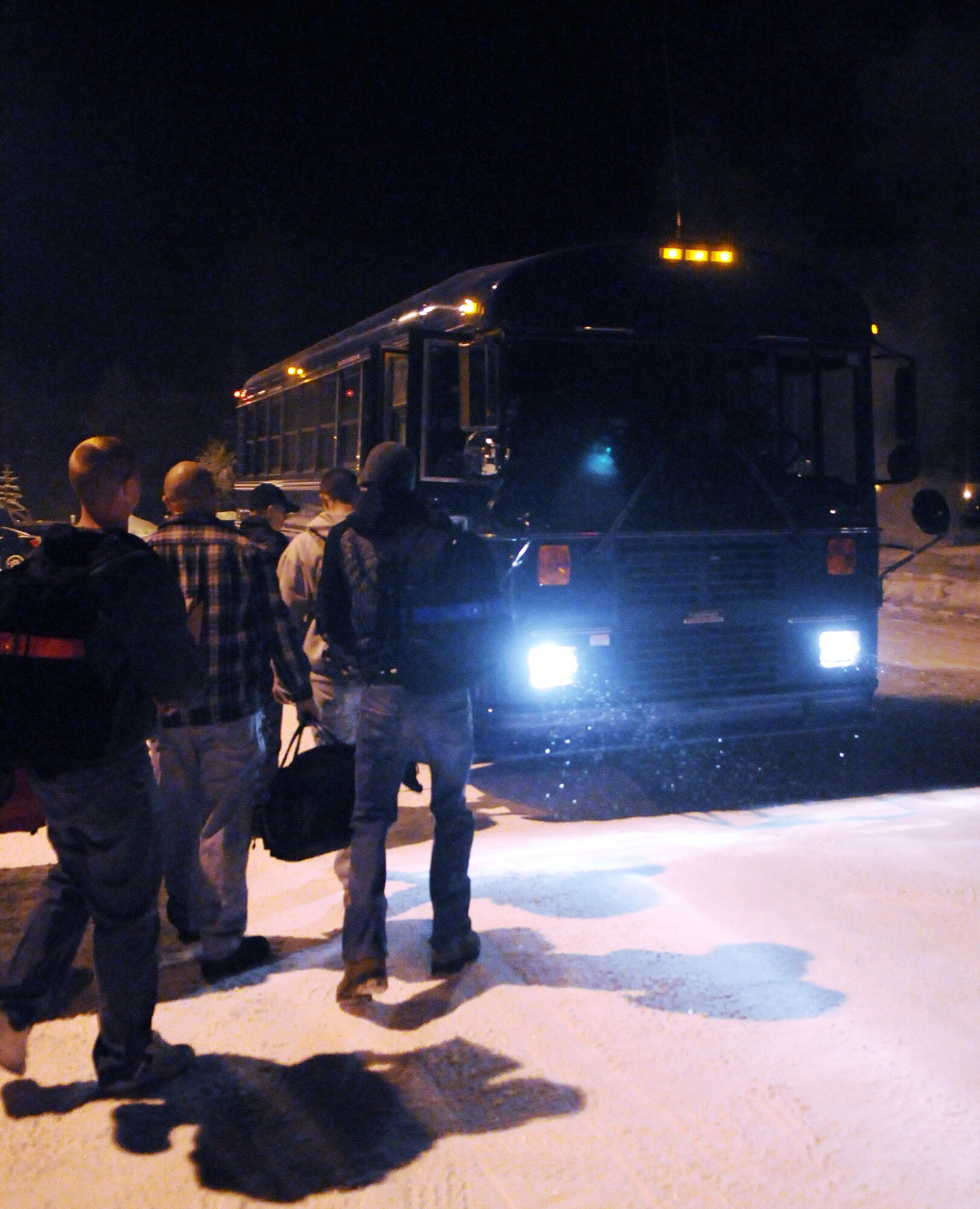 Airmen with the 354th Civil Engineer Squadron board a bus for transportation to the airport for an early flight Feb. 5, 2011, Eielson Air Force Base, Alaska. The Airmen flew to Kadena Air Base to participate in a two week Silver Flag traning exercise. (U.S. Air Force photo/Airman 1st Class Janine Thibault)