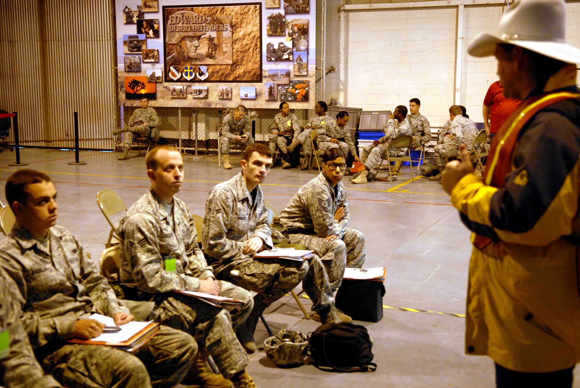 James Gray, 95th Force Support Squadron chief of readiness, briefs Airmen prior to them walking through the personnel deployment function line Feb. 16. The basewide Operational Readiness Exercise tested the capability of base personnel to prepare for a deployment at a moment?s notice. (Air Force photo by Senior Airman William A. O?Brien)