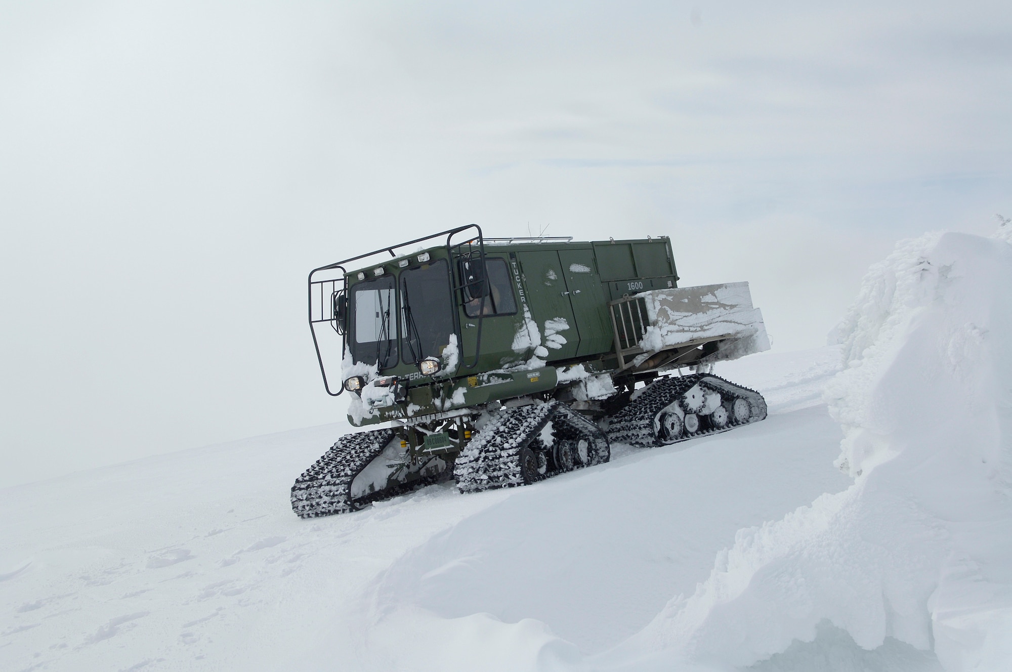 Transmission systems radio Airmen with the 92nd Communications Squadron and their guide from 336th Training Group get stuck in their enclosed all-terrain vehicle on their way up to a radio tower on the Calispell Mountain Peak in Spokane, Wash., Feb. 16, 2011. The vehicle got stuck a quarter mile away from the tower, which they have to deice throughout the year to maintain radio communications for the 336th Training Group and local law enforcement. The Airmen made their way up to the tower by shoveling snow off the path. (U.S. Air Force photo/ Senior Airman Natasha E. Stannard)
