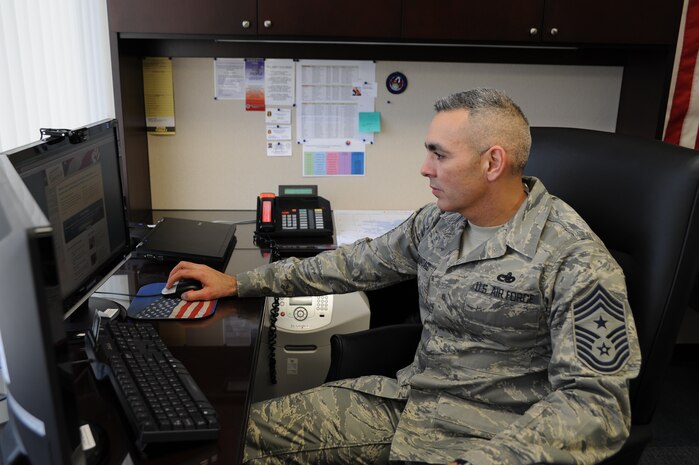 Chief Master Sgt. Jose LugoSantiago signs up on line for Military Saves Week. Chief LugoSantiago is the 628th AIrbase Wing command chief. (courtesy photo)