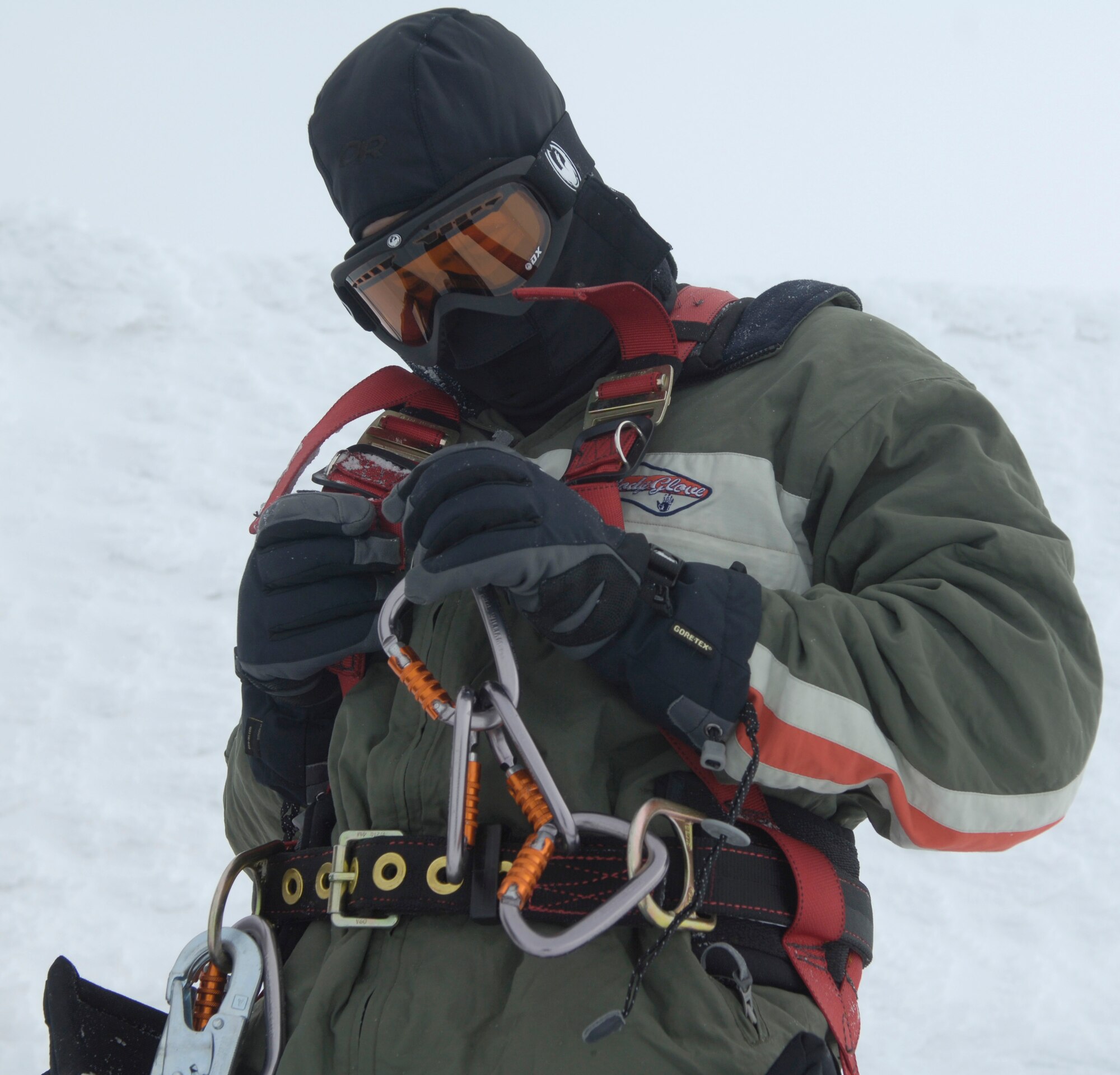 Airman 1st Class Shawn Westbrook fastens on his safety harness before climbing a radio tower Feb. 16, 2011 on the Calispell Mountain Peak in Spokane, Wash. Airman Westbrook is a transmission systems radio technician with the 92nd Communications Squadron and is climbing the tower to knock snow and ice off of it. Doing this provides better radio communication for the 336th Training Group and local law enforcement. (U.S. Air Force photo/ Senior Airman Natasha E. Stannard)