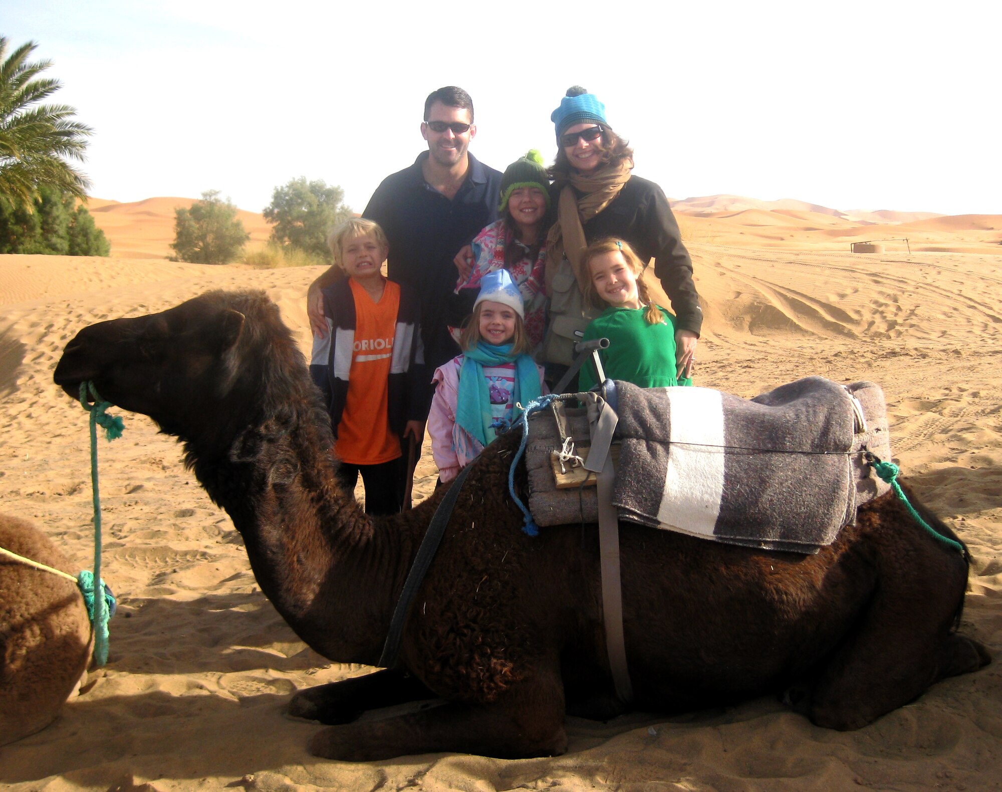 Lt. Col. Andy Hamann and family take a break during a camel ride while stationed at the American Embassy in Rabat, Morocco. Colonel Hamann, now an instructor pilot with the 8th Flying Training Squadron at Vance, went back to Morocco Feb. 1 to attend a T-6C Texan II trainer aircraft acceptance ceremony in Marrakech, at the invitation of the Moroccan air force chief of staff. (Courtesy photo)
