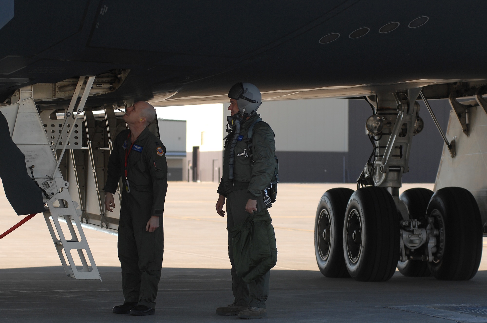 Tech Sgt. David Shockley, 509th Maintenance Group, (right) waits to climb aboard the B-2 Bomber to take his awarded orientation sortie Feb 22, 2011. Sgt. Shockley was awarded the flight after winning the 2009 eighth Air Force, crew chief of the year. (U.S. Air Force photo by Senior Airman Kenny Holston)(Released) 

