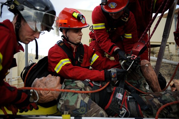 MOUNTAIN HOME AIR FORCE BASE, Idaho – The 366th Civil Engineering Squadron’s Senior Airman David Shaw, driver operator, Staff Sgt. Robert Casey, crew chief, and Mr. Steven Elliott, crew chief, rescue a simulated victim from a hole during the Unit Compliance Inspection Feb. 14. (U.S. Air Force photo by Airman 1st Class Renishia Richardson) 