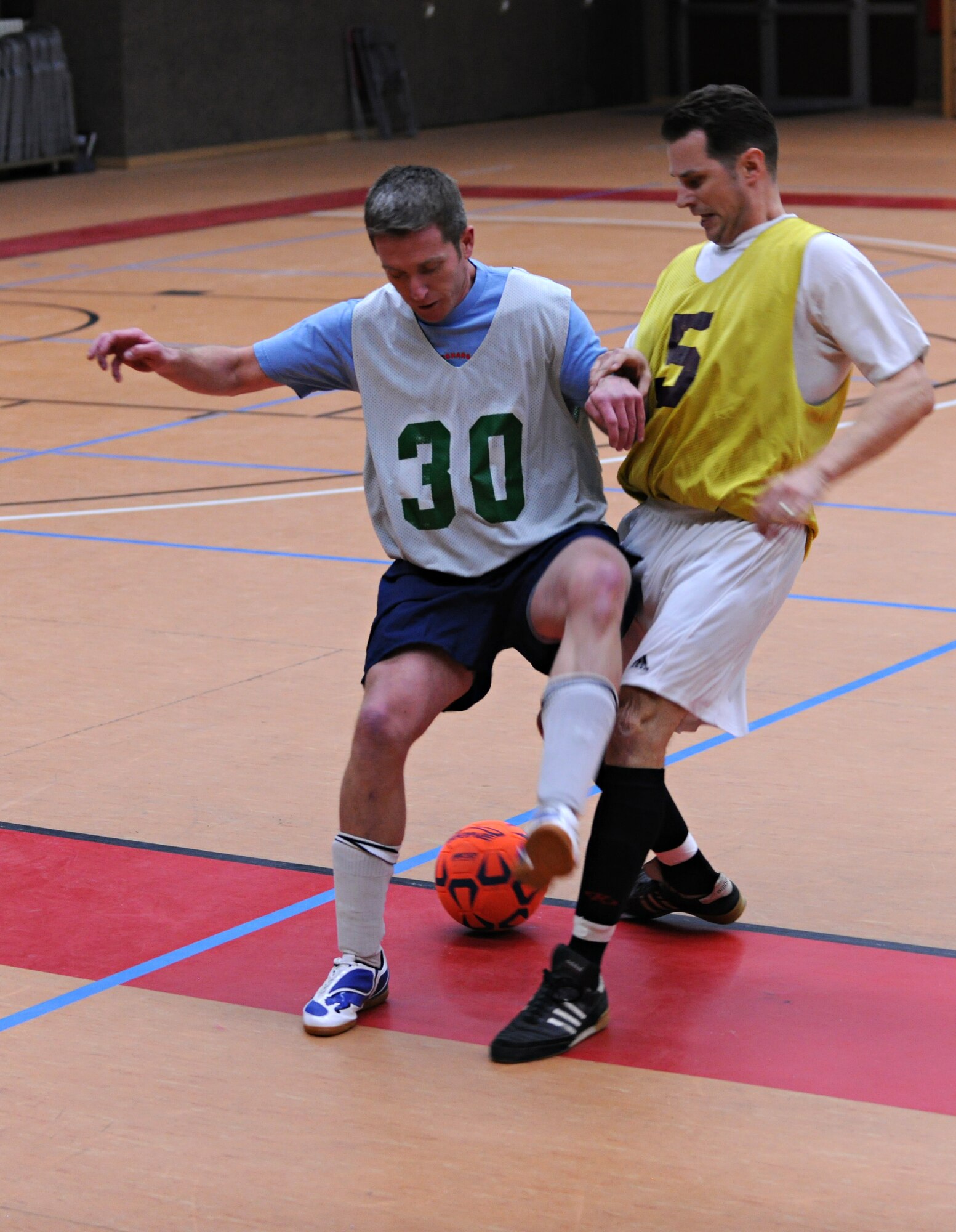SPANGDAHLEM AIR BASE, Germany – Andrew McGrath, left, 606th Air Control Squadron, tries to steal the ball from Benjamin Carpenter, 81st Fighter Squadron, during the first game of the indoor soccer season Feb. 22 at the Skelton Memorial Fitness Center. The 81st FS team crushed the 606th ACS 13-1. (U.S. Air Force photo/Staff Sgt. Benjamin Wilson)