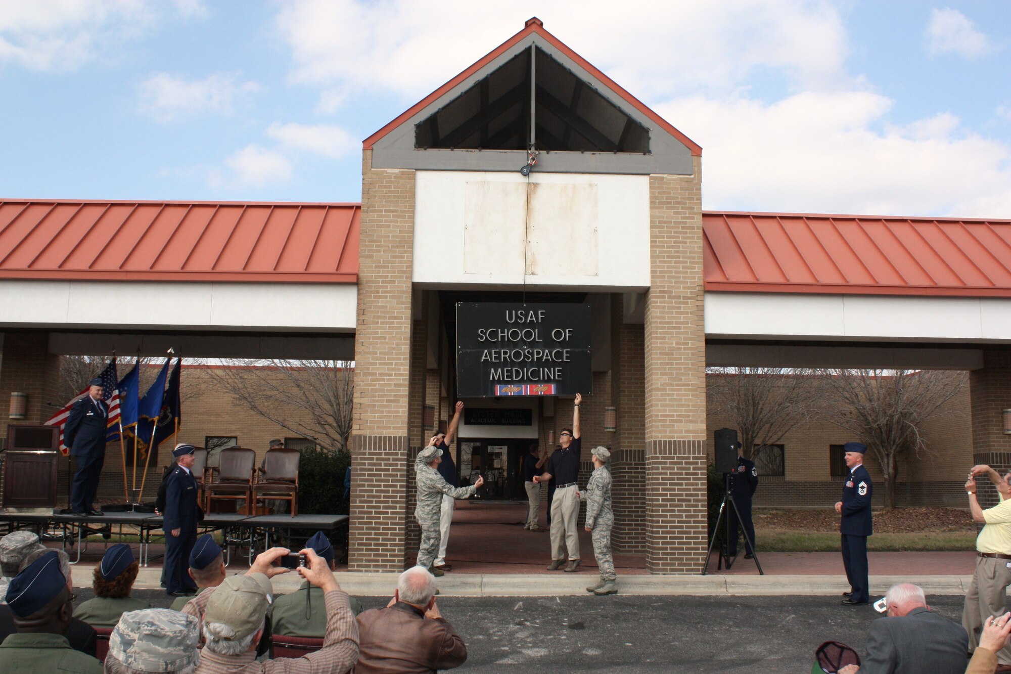 The USAF School of Aerospace Medicine celebrated its transition to Wright-Patterson AFB, OH on Thursday Feb. 17th at Brooks City-Base in San Antonio, TX.  The ceremony closed with the removal of one of the last remaining signs being removed from the schoolhouse building at Brooks City-Base and loaded onto a truck to be shipped to its new location at Wright-Patterson AFB, Ohio. USAFSAM is relocating from Brooks City-Base in San Antonio, Texas, to Wright-Patterson Air Force Base as part of the nation’s 2005 base realignment and closure decisions. The school is part of the Air Force Research Laboratory’s 711th Human Performance Wing. Photo by E'Lisa Wilcox, 711 HPW/XP.