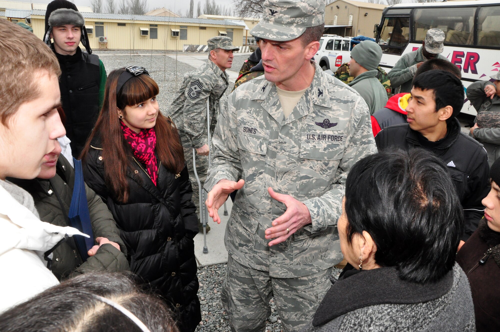 Col. Dwight Sones, 376th Air Expeditionary Wing commander, talks with high school students from Leninskoye village participating in a first-ever Kyrgyz-U.S. Military Orientation Day at the Transit Center Feb 22. After briefings on life in both countries’ services, the students were given a tour on various aspects of the Transit Center and KC-135 Stratotanker as well. (U.S. Air Force photo/Master Sgt. Daniel Nathaniel)