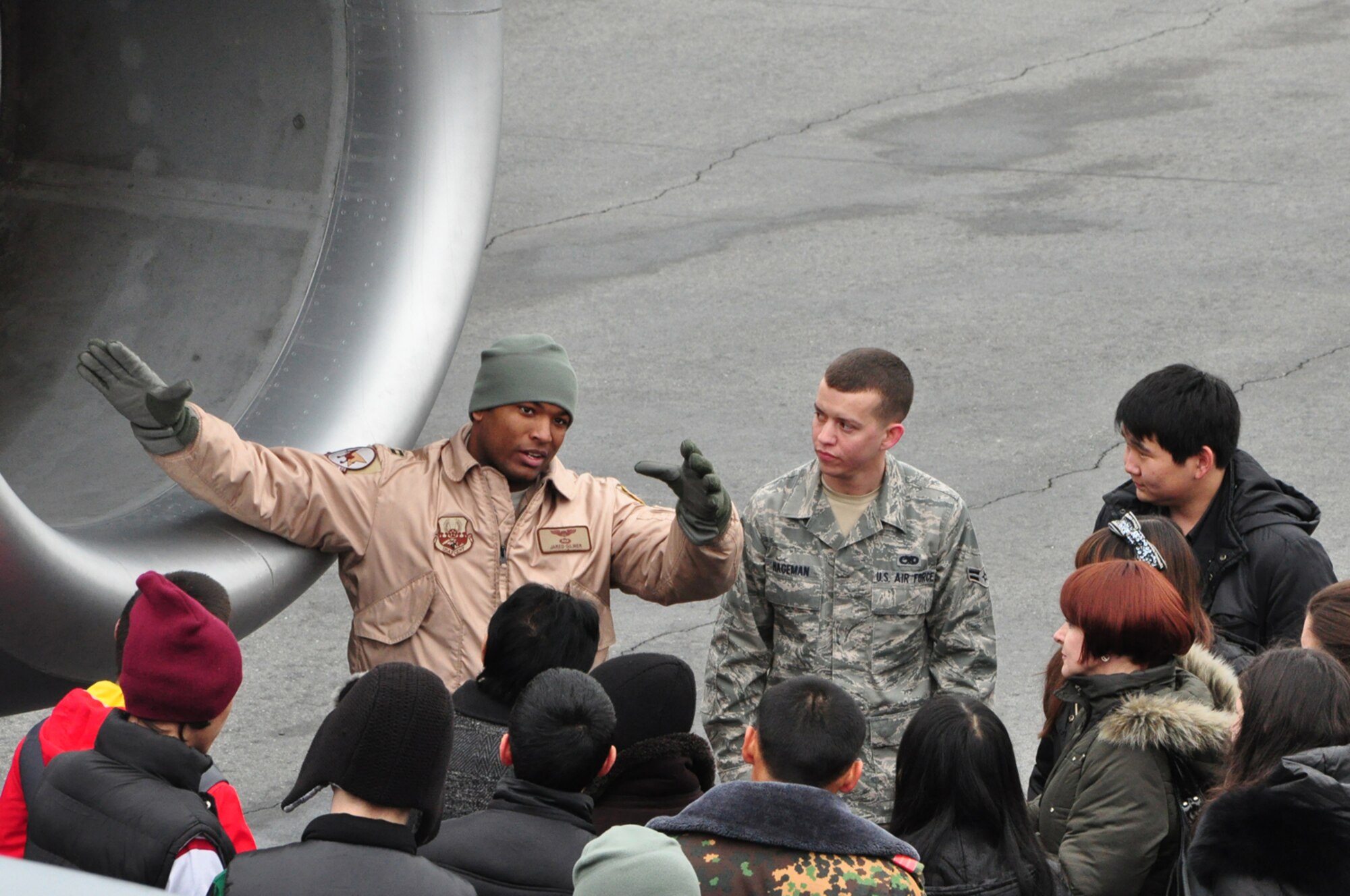 Captain Jared Gilmer explains the workings of the C-17 Globemaster III to high school students from Leninskoye village. The students were part of a first-ever Kyrgyz-U.S. Military Orientation Day here Feb 22. After briefings on life in both countries’ services, the students were given a tour on various aspects of the Transit Center and KC-135 Stratotanker as well. (U.S. Air Force photo/Master Sgt. Daniel Nathaniel)