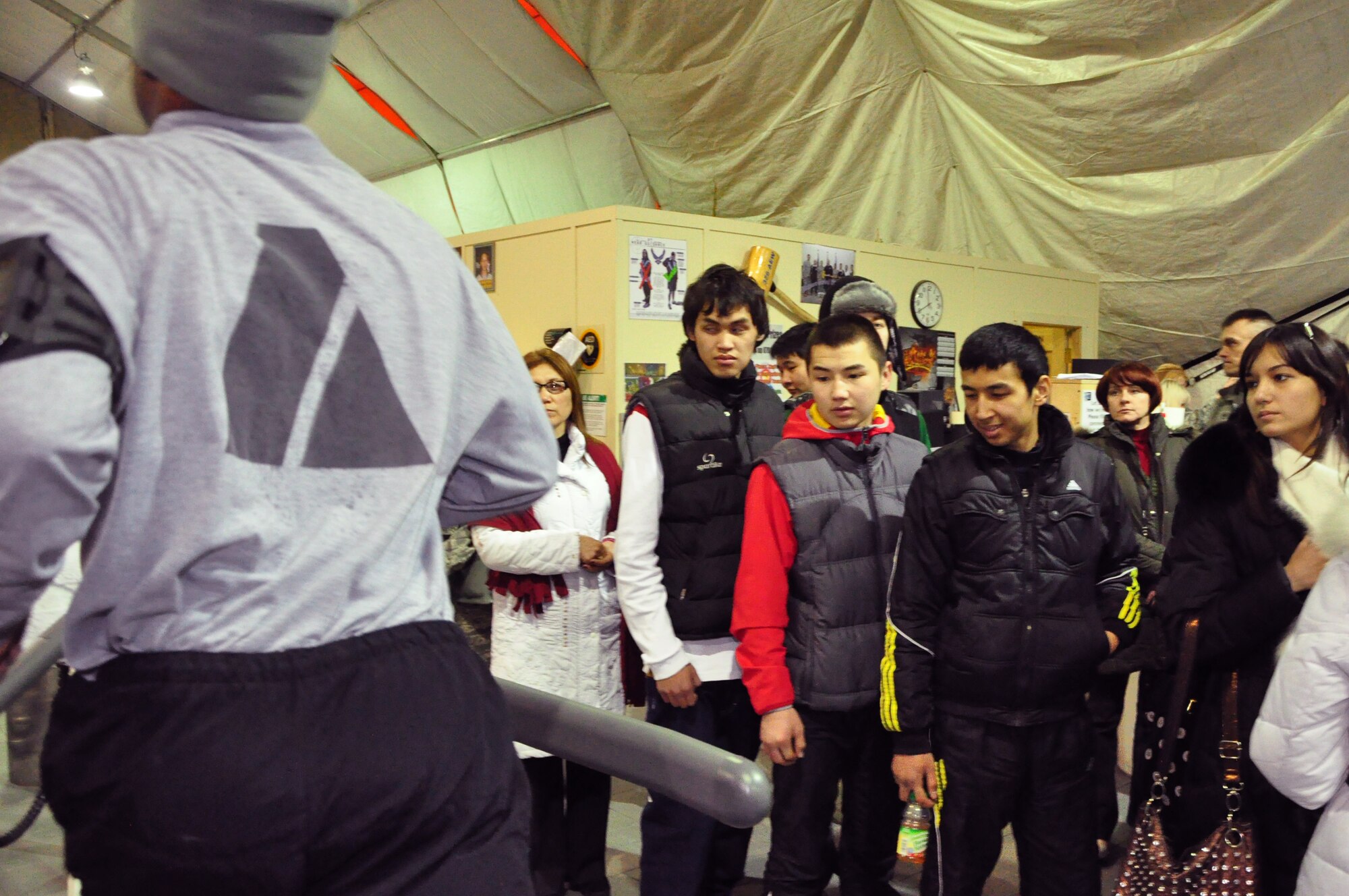 High school students from Leninskoye village tour the Fitness Center at the Transit Center at Manas. The students were part of a first-ever Kyrgyz-U.S. Military Orientation Day here Feb 22. After briefings on life in both countries’ services, the students were given a tour on various aspects of the Transit Center  as well as the C-17 Globemaster III and KC-135 Stratotanker. (U.S. Air Force photo/Master Sgt. Daniel Nathaniel)
