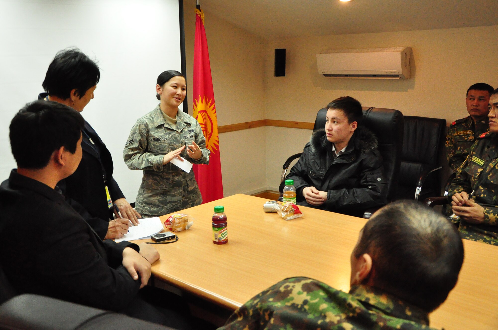 Airman 1st Class Yang Vang explains to students from Leninskoye village about her efforts leading up to enlisting in the U.S. Air Force. The students were part of a first-ever Kyrgyz-U.S. Military Orientation Day at the Transit Center Feb 22. After briefings on life in both countries’ services, the students were given a tour on various aspects of the Transit Center  as well as the C-17 Globemaster III and KC-135 Stratotanker. (U.S. Air Force photo/Master Sgt. Daniel Nathaniel)