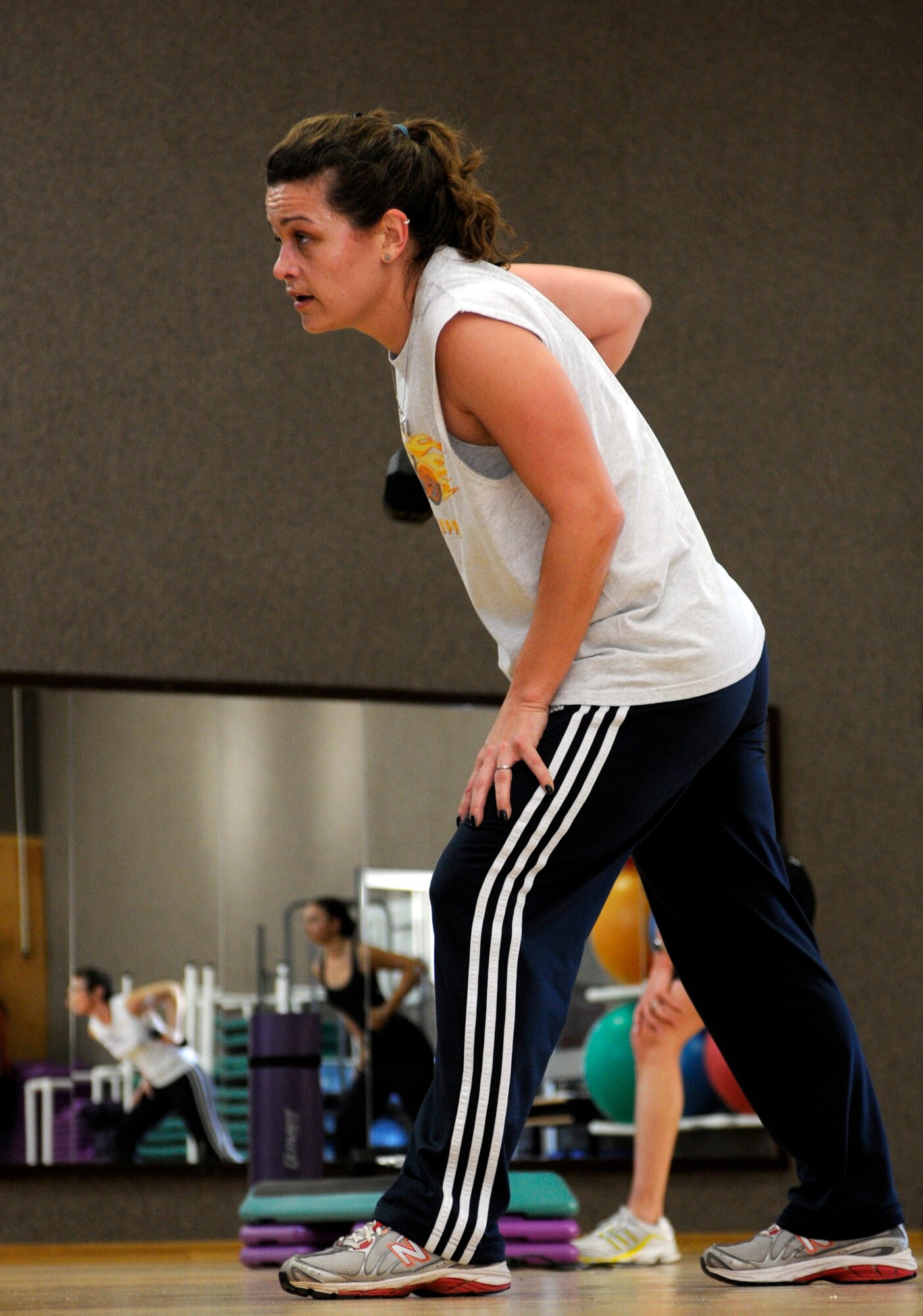 SPANGDAHLEM AIR BASE, Germany – Fiona Cook, Spangdahlem Air Base fitness instructor, performs a one-armed standing row during an Abs Bootcamp aerobics class Feb. 22 at the Skelton Memorial Fitness Center. The Abs Bootcamp, MaxFIT and Butts and Guts are a few of the many classes offered to improve levels of fitness for Sabers. (U.S. Air Force photo/Senior Airman Clay Murray)