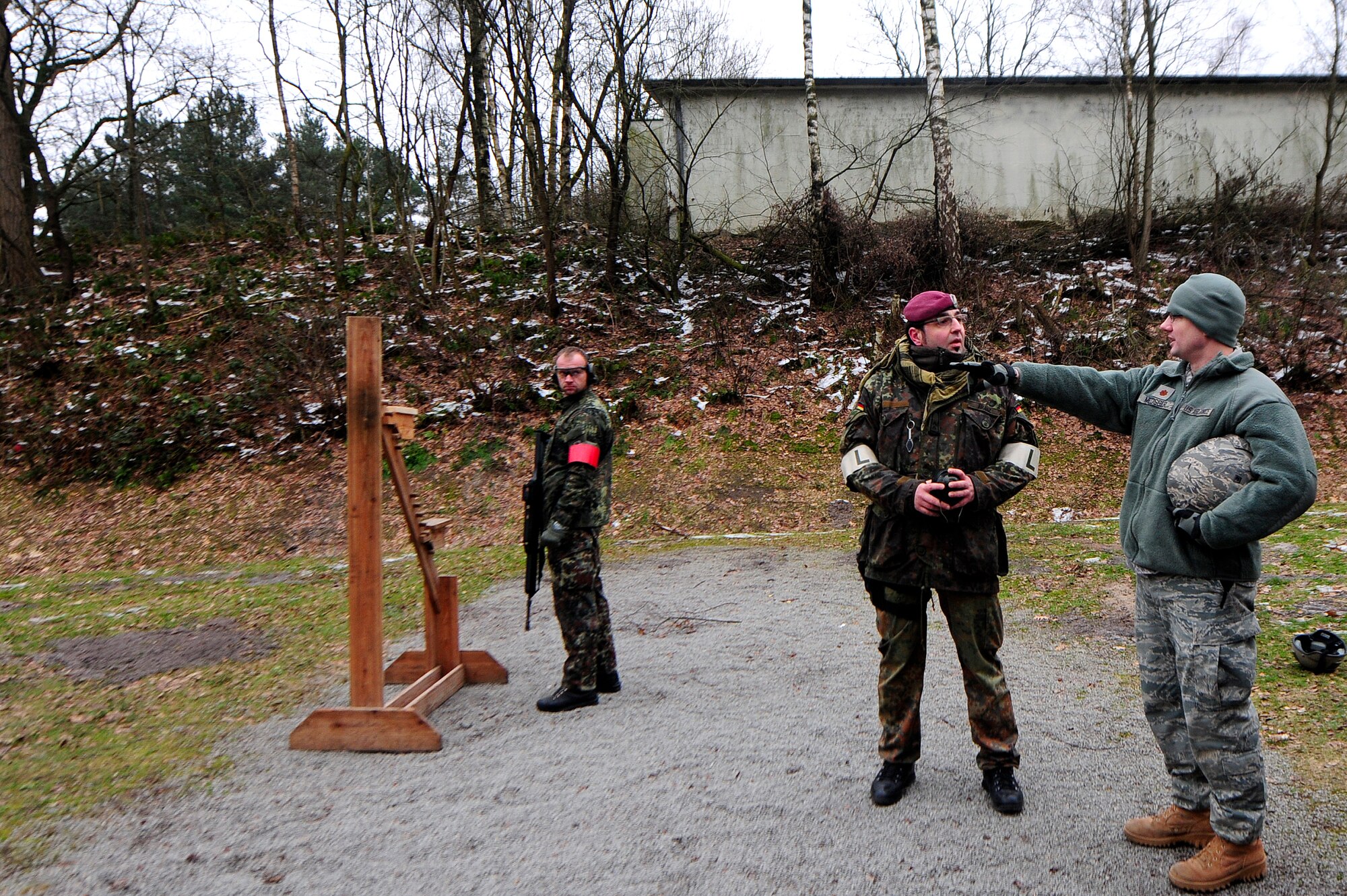 Maj. Jason Medsger, 435th Security Forces Squadron commander, receives weapon familiarization training by personnel from the 31st German Airborne Brigade, Oldenburg, Germany, Feb. 18, 2011. Members from the 435th Contingency Response Group attended the German shooting competition, "Sch?tzenschnur," where they trained and earned a German Shooting Proficiency Badge. The visit was not only for weapons familiarization and the competition, but to enhance the relationship with the German forces. (U.S. Air Force photo by Airman 1st Class Brea Miller)