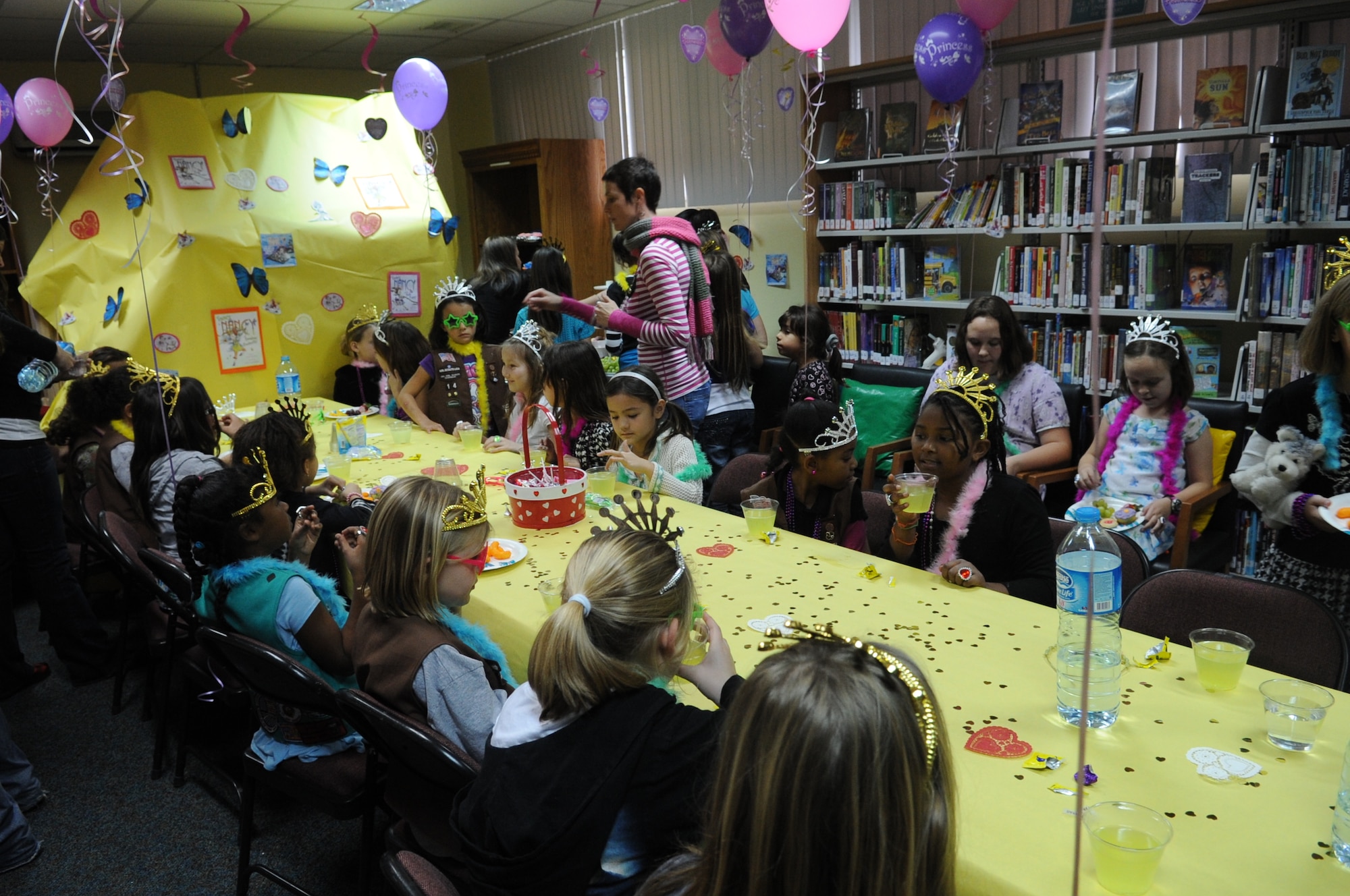 Participants enjoy refreshments Feb. 15, 2011, at the Fancy Nancy Tea Party at Incirlik Air Base, Turkey. The tea party was held at the base library for girls ages 6-10 to help promote and continue community involvement with the children on Incirlik. The participants received tiaras, sunglasses, necklaces and feather boas. The girls also made purses and wands during the event (U.S. Air Force photo by Airman 1st Class Clayton Lenhardt)