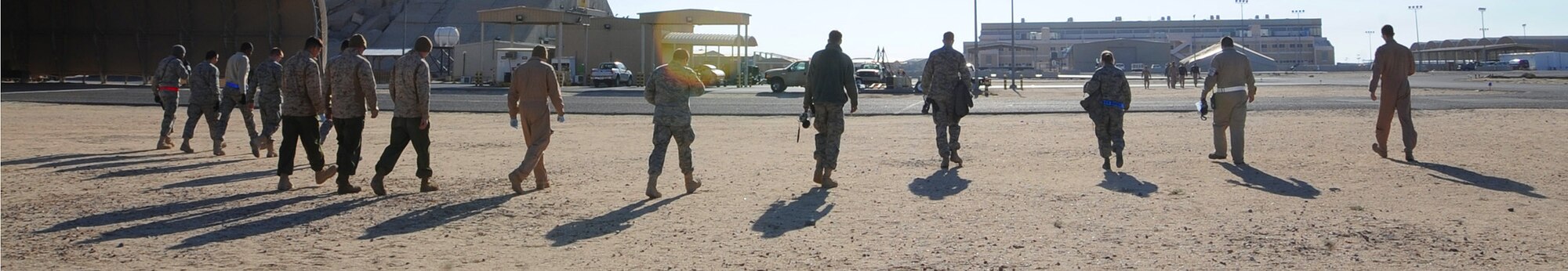 Airmen with the 386th Air Expeditionary Wing participate in the quarterly foreign object disposal walk on the flightline Feb. 19. A FOD walk is done to ensure that the flightline is free of any debris that may effect the safety of air transportation. (U.S. Air Force photo by Senior Airman Cynthia Spalding)