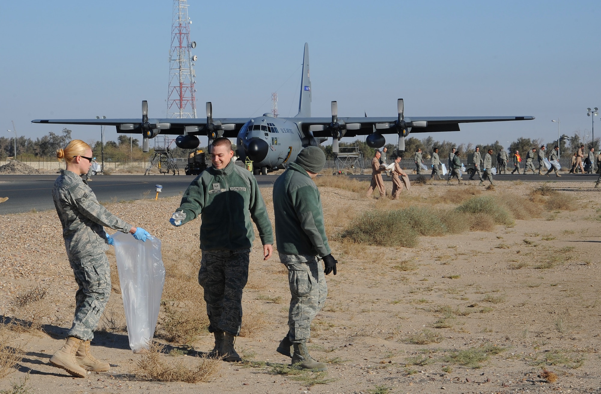 Airmen with the 386th Air Expeditionary Wing participate in the quarterly foreign object disposal walk on the flightline Feb. 19. A FOD walk is done to ensure that the flight line is free of any debris that may effect the safety of air transportation. (U.S. Air Force photo by Senior Airman Cynthia Spalding)