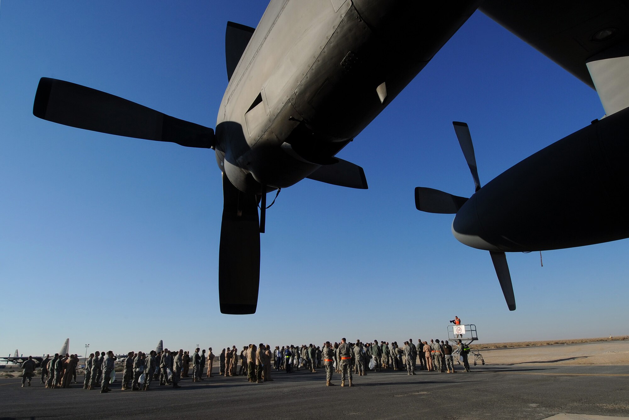Airmen with the 386th Air Expeditionary Wing participate in the quarterly foreign object disposal walk on the flightline Feb. 19. A FOD walk is done to ensure that the flightline is free of any debris that may effect the safety of air transportation. (U.S. Air Force photo by Senior Airman Cynthia Spalding)