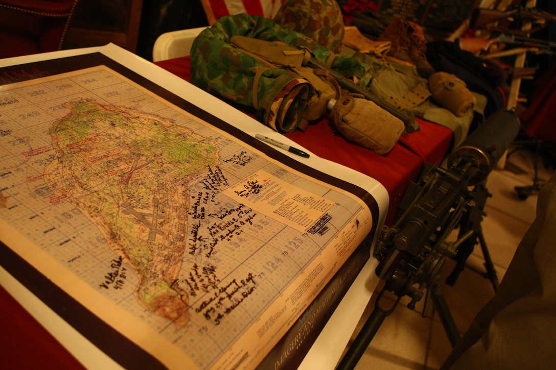 A Map of Iwo Jima sits covered with the signatures of Marine veterans of the World War II battle during the First Annual Iwo Jima Memorial Service at the Indiana War Memorial Museum Feb. 23.  Detachment 1, Communications Company, Headquarters and Service Battalion, 4th Marine Logistics Group invited more than a dozen Iwo Jima Marine veterans from across Indiana to the event to honor their service on Iwo Jima.