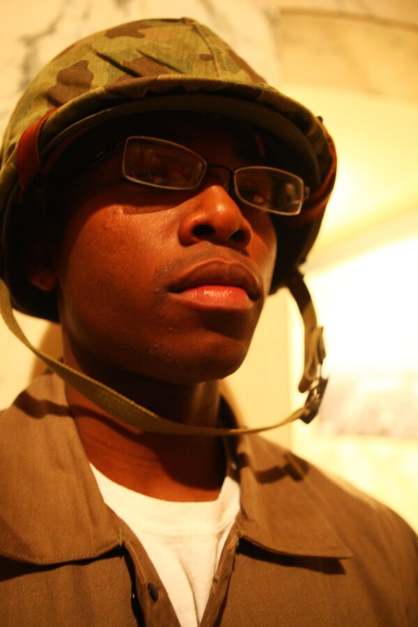 Lance Cpl. Fred Berry, a radio operator with Detachment 1, Communications Company, Headquarters and Service Battalion, 4th Marine Logistics Group, displays a World War II-era Marine uniform during the First Annual Iwo Jima Memorial Service at the Indiana War Memorial Museum Feb. 23.  The Peru, Ind., Reserve unit invited more than a dozen Iwo Jima Marine veterans from across Indiana to the event to honor their service on Iwo Jima.