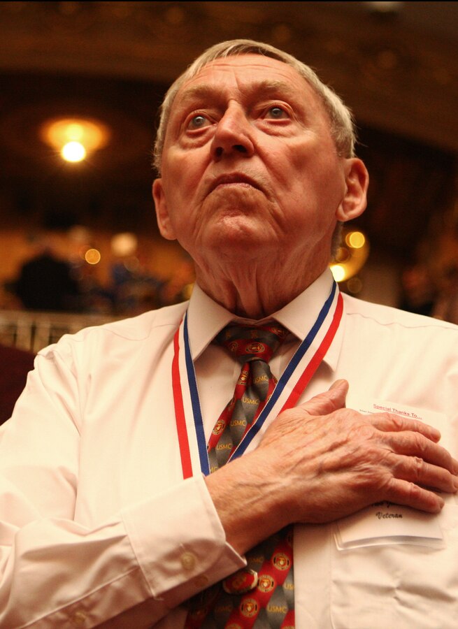 Iwo Jima vet Ralph Swartsell stands for the playing of the national anthem during the First Annual Iwo Jima Memorial Service at the Indiana War Memorial Museum Feb. 23.  Detachment 1, Communications Company, Headquarters and Service Battalion, 4th Marine Logistics Group invited more than a dozen Iwo Jima Marine veterans from across Indiana to the event to honor their service on Iwo Jima.