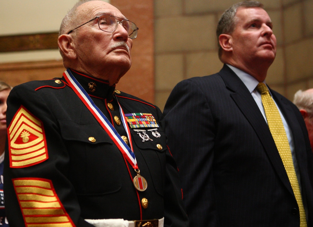 Iwo Jima veteran Robert S. Crouch, one of the memorial service’s two guests of honor, stands with Mayor Gregory A. Ballard during the First Annual Iwo Jima Memorial Service at the Indiana War Memorial Museum Feb. 23.  Detachment 1, Communications Company, Headquarters and Service Battalion, 4th Marine Logistics Group invited more than a dozen Iwo Jima Marine veterans from across Indiana to the event to honor their service on Iwo Jima.