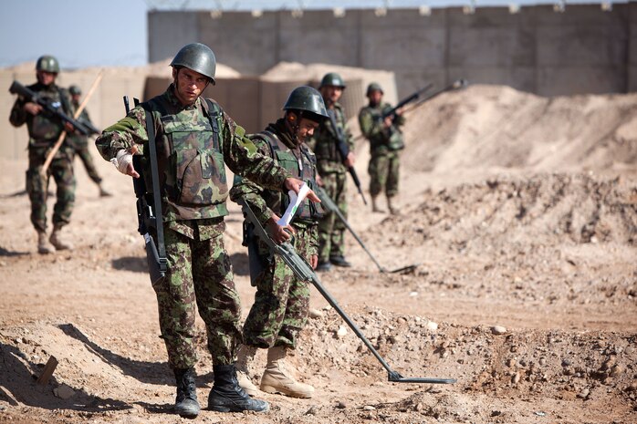Afghan National Army soldiers with Route Clearance Company, 1st Brigade, 215th Corps, scour an improvised explosive device course at Camp Dwyer, Helmand province, Afghanistan, Feb. 23.