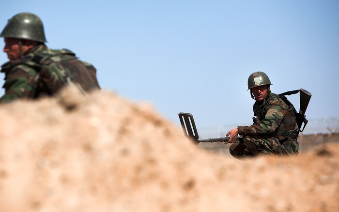 Afghan National Army soldiers with Route Clearance Company, 1st Brigade, 215th Corps, scour an improvised explosive device course at Camp Dwyer, Helmand province, Afghanistan, Feb. 23.