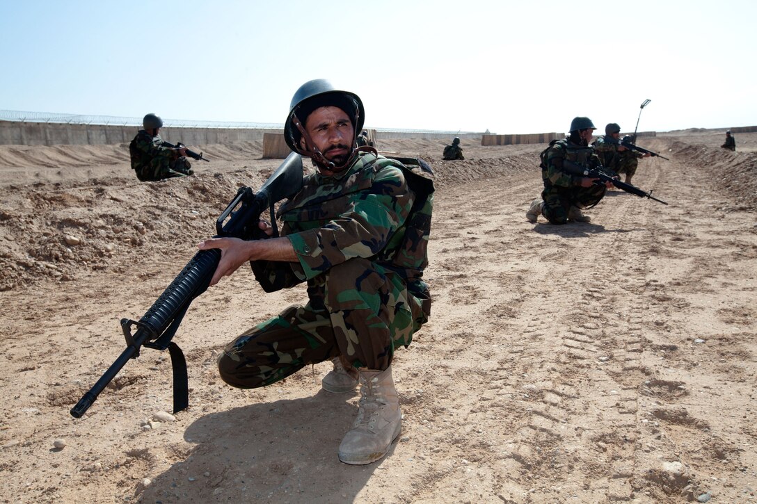 Afghan National Army soldiers with Route Clearance Company, 1st Brigade, 215th Corps, provide 360-degree security after one of the soldiers discovers a simulated improvised explosive device at the IED course at Camp Dwyer, Helmand province, Afghanistan, Feb. 23.