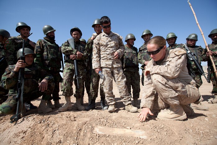 Staff Sgt. Ladonna Prosser, the explosive ordnance disposal team leader at Camp Dwyer, debriefs Afghan National Army soldiers with Route Clearance Company, 1st Brigade, 215th Corps, on a pressure plate they discovered at improvised explosive device course at Camp Dwyer, Helmand province, Afghanistan, Feb. 23. Prosser is from Amarillo, Texas.