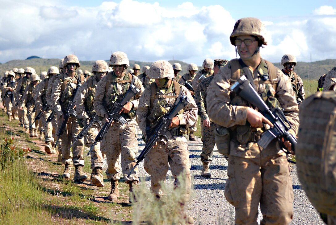 On the improvised explosive device detection course, recruits walk in tactical columns during the Crucible, staying alert for anything suspicious. Field instructors set up a trip wires and simulated IEDs to see if the recruits can spot them.