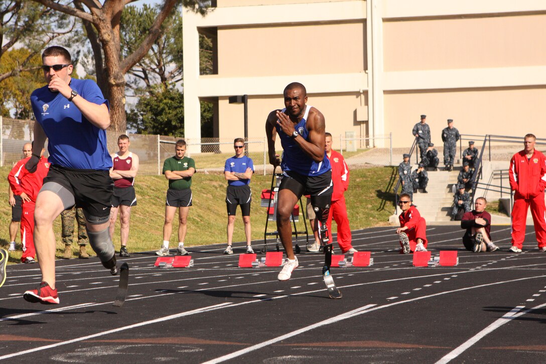Lee Randles (right) sprints during a 100-meter race in the track and field portion of the 2011 Marine Corps Trials at Camp Pendleton, Feb. 25. Lee, who also participated in the sitting volleyball, swimming and 100-200 meter relays, lost his leg in a motorcycle accident in 2005. The participants were able to compete in wheelchair basketball, sitting volleyball, archery, swimming, shooting, track and field, and cycling during the 10-day event.
