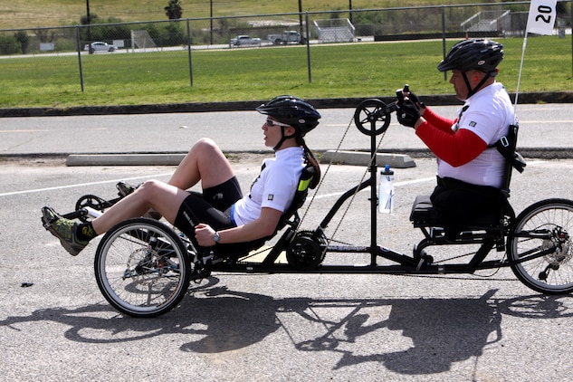 Chuck Sketch, a swimmer, shooter and cyclist for the Veterans Team, rides a two-passenger bike with Maj. Susan Stark, the event director, during one of the Camp Pendleton 2011 Marine Corps Trials 10 kilometer cycling competitions, Feb. 23. Stark acts as Sketch's eyes as he uses the hand cranks to power the duo. Sketch, a native of Wildomar, Calif., lost his sight from brain cancer in 1997 and lost both of his legs due to complications with blood clots in 1998.