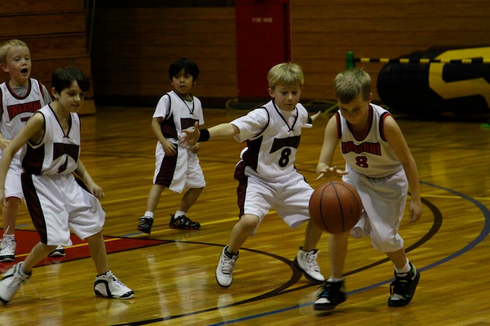 Landon Rakestraw, Heat point guard, covers Bryce Rupple, Bulls power forward, as he attempts to get open for a shot during a 7- to 9-year-old youth basketball season game at the IronWorks Gym sports courts here Feb. 24. The Heat’s defense flared up, but the Bull’s exceptional passing kept the Heat players at bay.