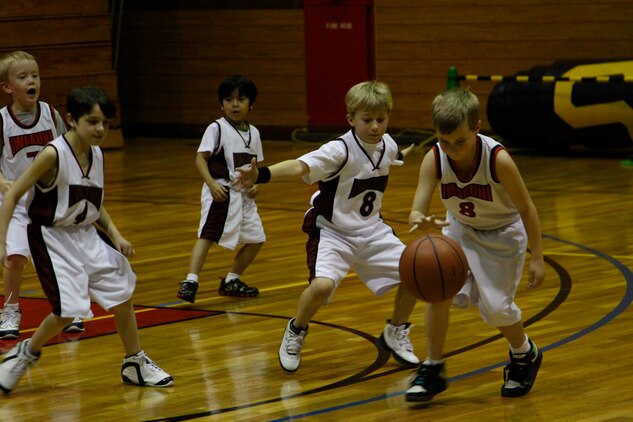 Landon Rakestraw, Heat point guard, covers Bryce Rupple, Bulls power forward, as he attempts to get open for a shot during a 7- to 9-year-old youth basketball season game at the IronWorks Gym sports courts here Feb. 24. The Heat’s defense flared up, but the Bull’s exceptional passing kept the Heat players at bay.