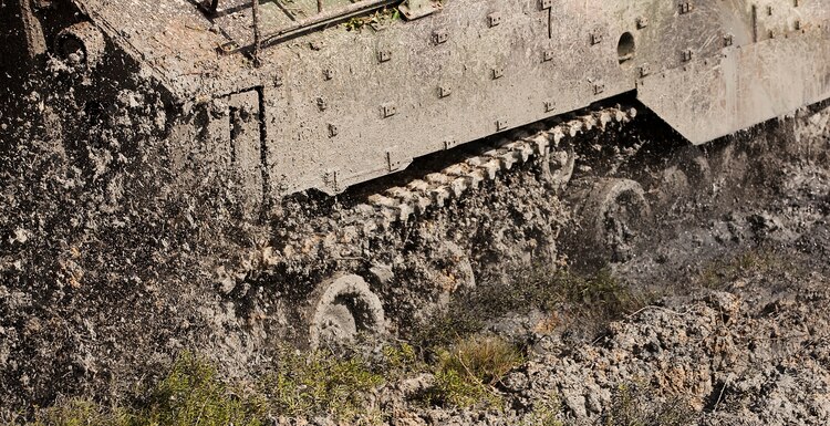 The spinning track of an amphibious assault vehicle with AAV Platoon, Combat Assault Company, 3rd Marine Regiment, sends mud flying as it tears up invasive pickleweed in the Nuupia Ponds Wildlife Management Area during the 29th annual Mud Ops exercise on Marine Corps Base Hawaii, Feb. 23, 2011. The 29-year-long Mud Ops tradition partnered AAV Platoon Marines with the base Environmental Compliance and Protection Department to prepare the 517-acre area for the upcoming breeding season of the endangered Hawaiian stilt bird species, which lasts from March until September.