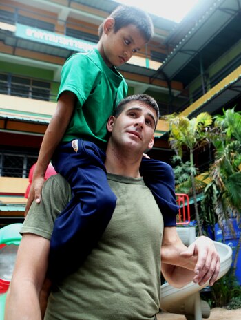 Lance Cpl. Randolph Pitts, 22, of Vinalhaven, Maine, a heavy equipment mechanic with Combat Logistics Battalion 31, 31st Marine Expeditionary Unit, carries a blind Thai child on his shoulders during a community relations event, Feb. 24. Marines and Sailors assisted at the Father Ray Foundation School for the Blind during a port visit after the 31st MEU’s successful conclusion of Cobra Gold 2011.  The 31st MEU is the nation’s only continually forward deployed MEU, and remains a force-in-readiness in the Asia-Pacific region.