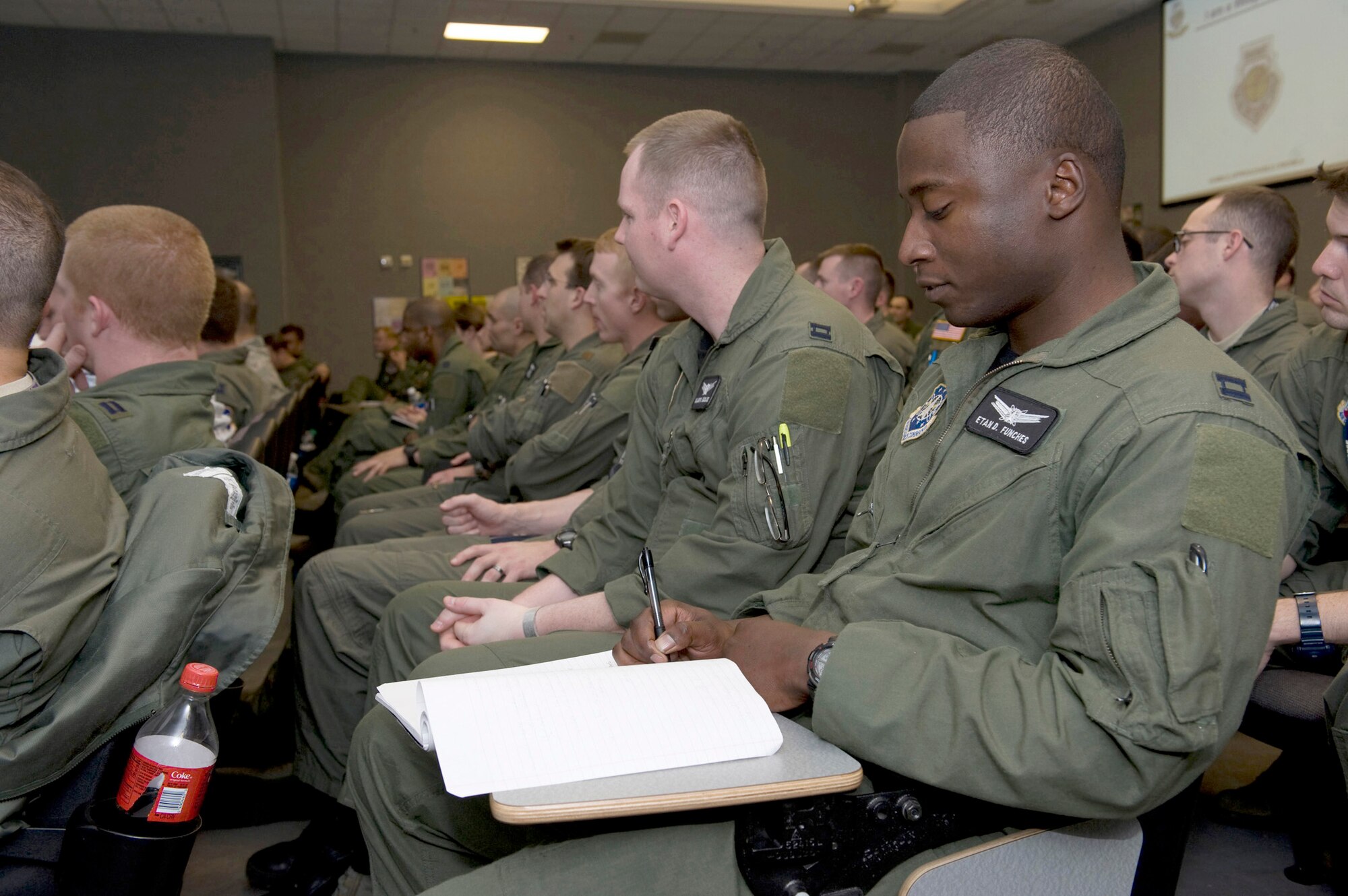 Capt. Etan Funches, takes notes during a leadership course presented by Simon Sinek, an internationally renowned speaker and author, Feb. 22, 2011, at Nellis Air Force Base, Nev. Mr. Sinek helped U.S. Air Force Weapons School officials develop a new curriculum focused on creating the next generation of Air Force leaders and helped introduce the program to students. Captain Funches is a U.S. Air Force Weapons School student. (U.S. Air Force photo/Senior Airman Brett Clashman)
