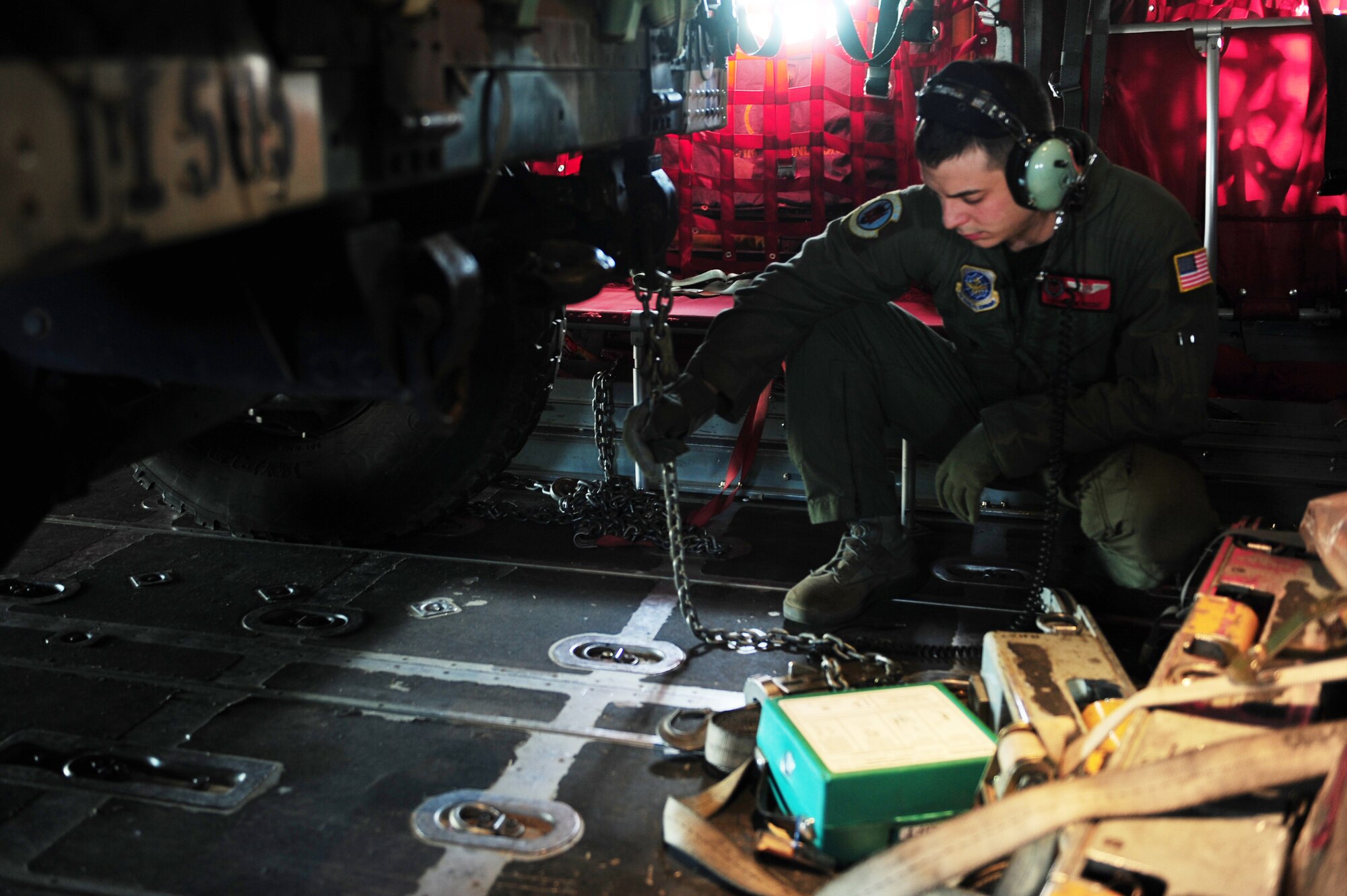 Senior Airman Nick Rizzo, a 50th Airlift Squadron loadmaster, straps down a humvee on a C-130H during a Joint Operational Access Exercise Feb. 14, 2011 at Pope Air Force Base, N.C. The exercise trains Soldiers and Airmen to deploy at a moment’s notice and sustain the mission anywhere in the world. (Photo by U.S. Air Force Senior Airman Jim Araos)