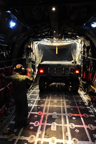 Senior Airman Bart Johnson, a 50th Airlift Squadron loadmaster, backs up a humvee on a C-130H during a Joint Operational Access Exercise Feb. 14, 2011 at Pope Air Force Base, N.C. The exercise trains Soldiers and Airmen to deploy at a moment’s notice and sustain the mission anywhere in the world. (Photo by U.S. Air Force Senior Airman Jim Araos)