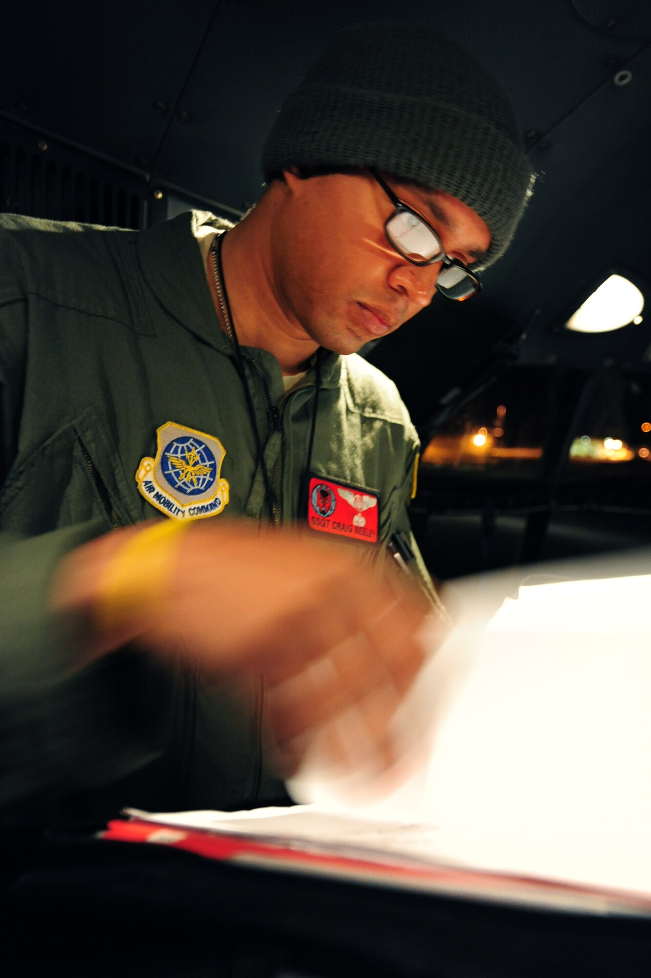 Staff Sgt. Craig Neeley, a 50th Airlift Squadron flight engineer, monitors the flight systems on a C-130H during a Joint Operational Access Exercise Feb. 14, 2011 at Pope Air Force Base, N.C. The exercise trains Soldiers and Airmen to deploy at a moment’s notice and sustain the mission anywhere in the world. (Photo by U.S. Air Force Senior Airman Jim Araos)